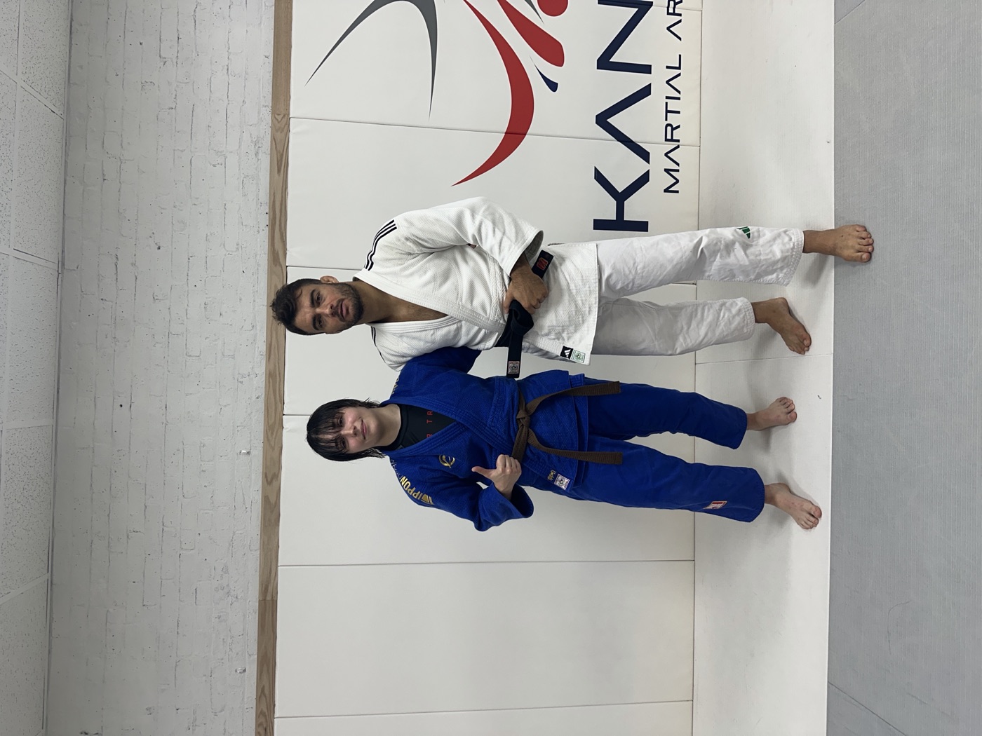Maria Galanty in a blue gi beside Fabio Basile in a white gi at Kano Martial Arts